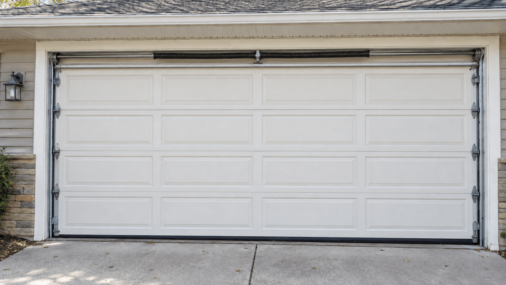 Dirty and worn residential garage door before preventive maintenance in South Houston TX